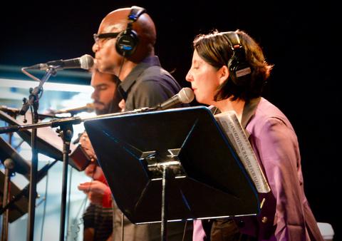 Coco&#039;s Barrio actors on stage for a live radio theater performance