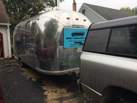 Newly purchased Airstream hitched to Darrold's pickup Photo of Airstream hooked up to pickup truck in driveway.