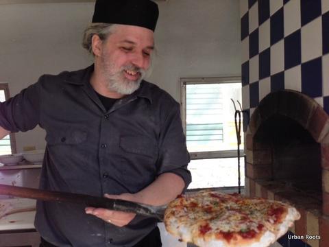 Barry pulls pizza from Airstream oven Photo of Barry removing pizza from Airstream oven