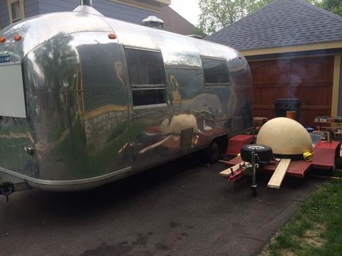 Oven on trailer in driveway with Airstream silver trailer