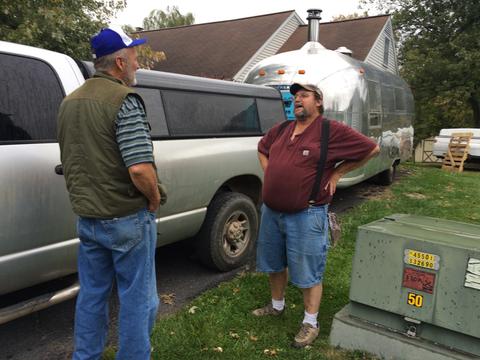 Photo of Darrold and Stephen in driveway beside trailer and pickup.