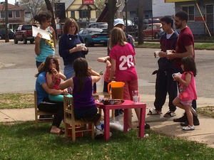 Photo of people around children's lemonade stand.