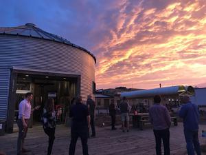 Photo of multi-colored sunset beside Bang&#039;s grain silo building